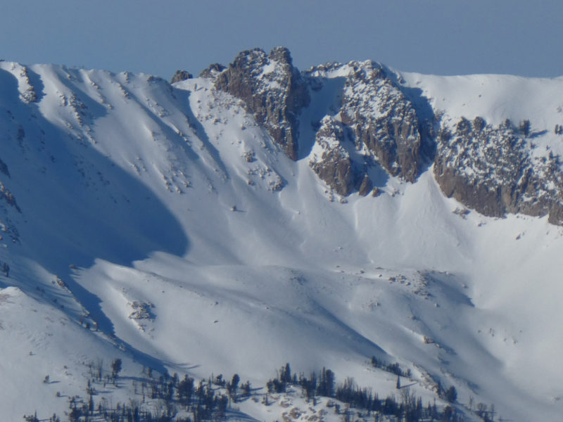 Remnants of avalanches that failed during the prolonged storm event that began on December 11th. Avalanche debris is visible below the main chutes. It also looks like at least one slab pulled out below a mid-slope rock band, potentially triggered from above. Soldier Mountains. 9,400' E.